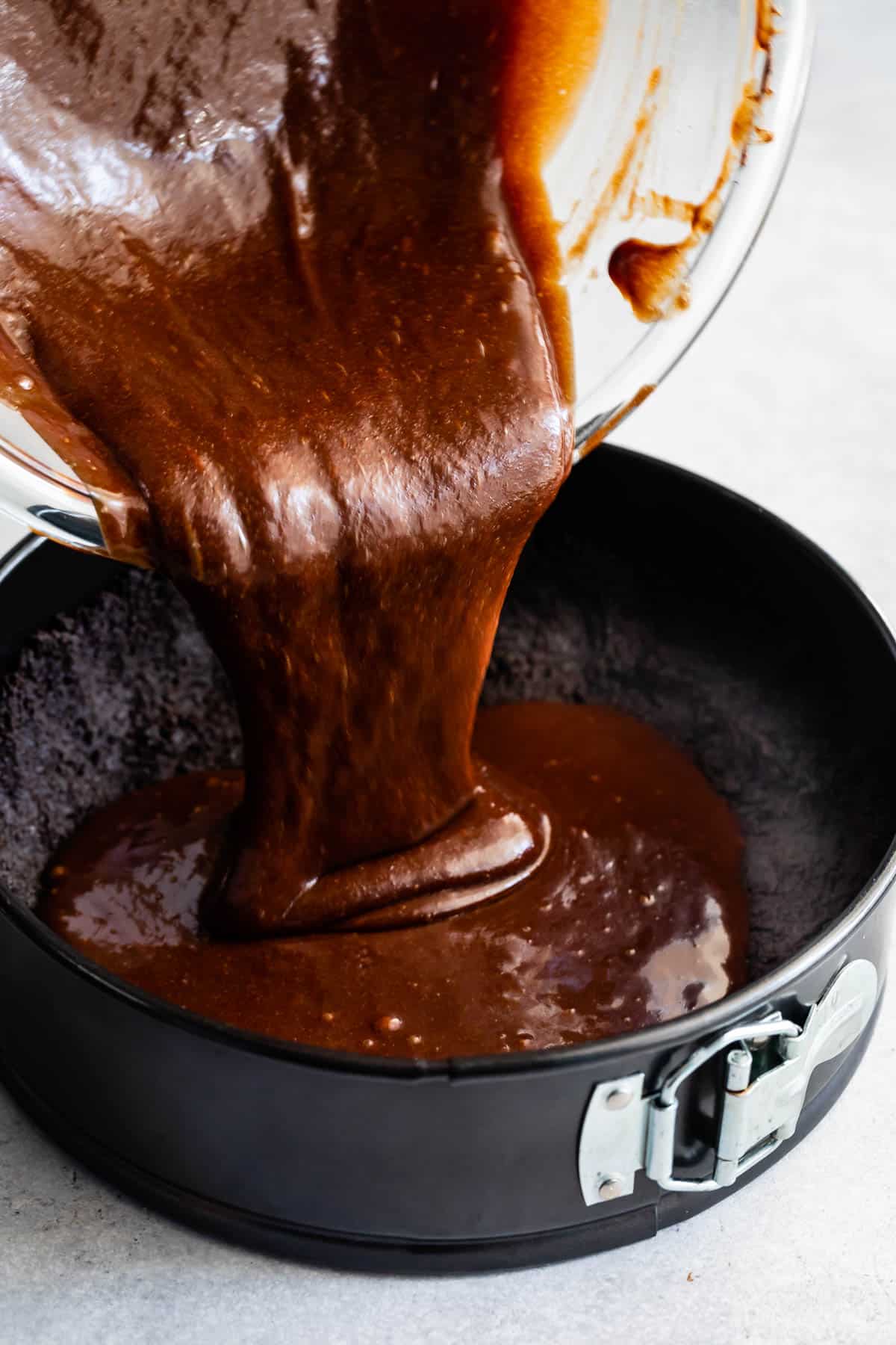 pouring batter into crust in pan.