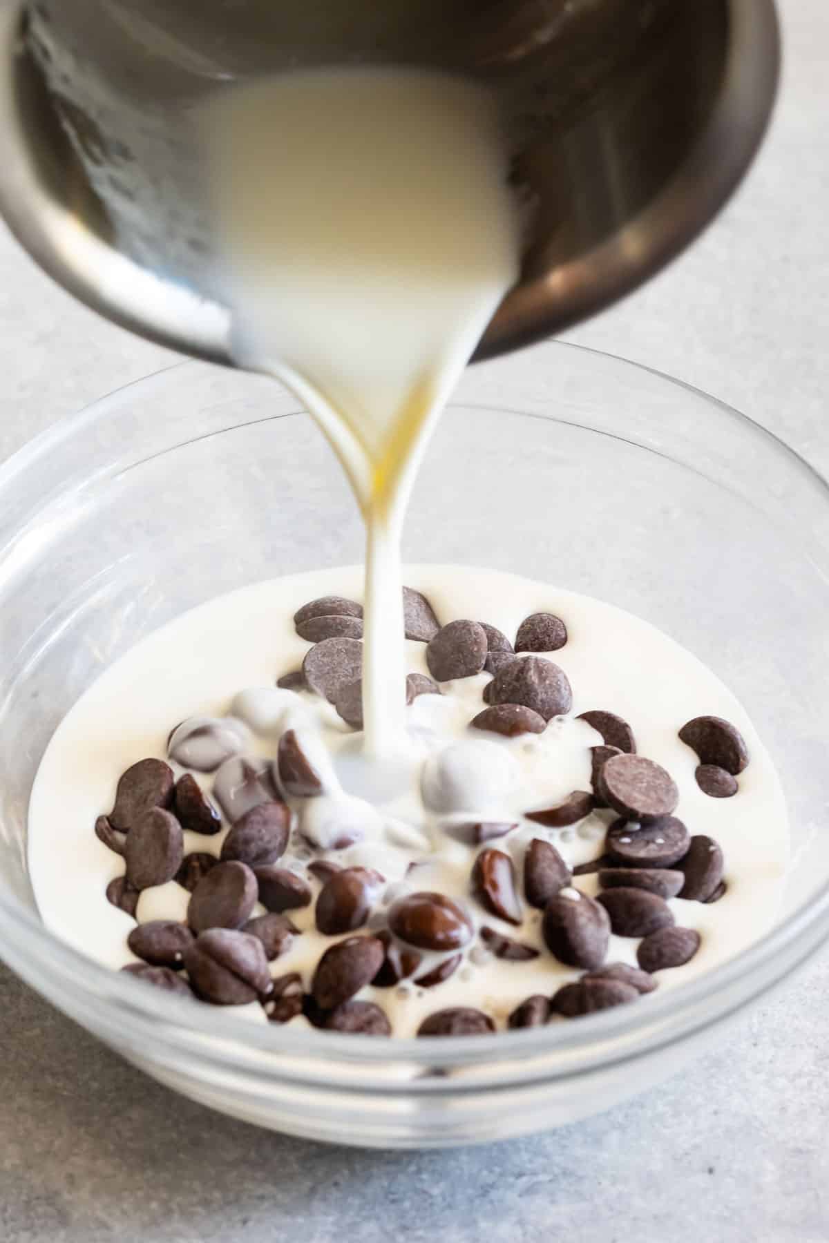 pouring cream onto chocolate chips.