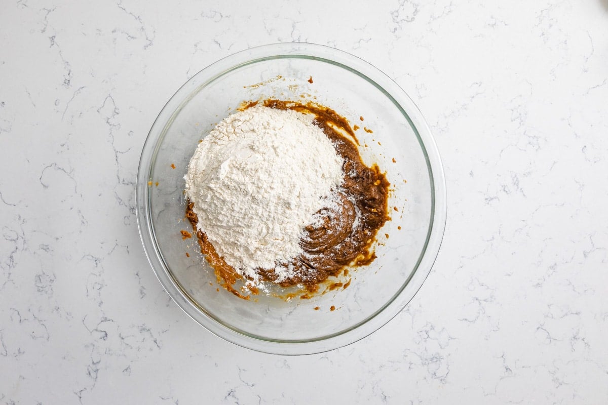 molasses cookie dough with flour in bowl.