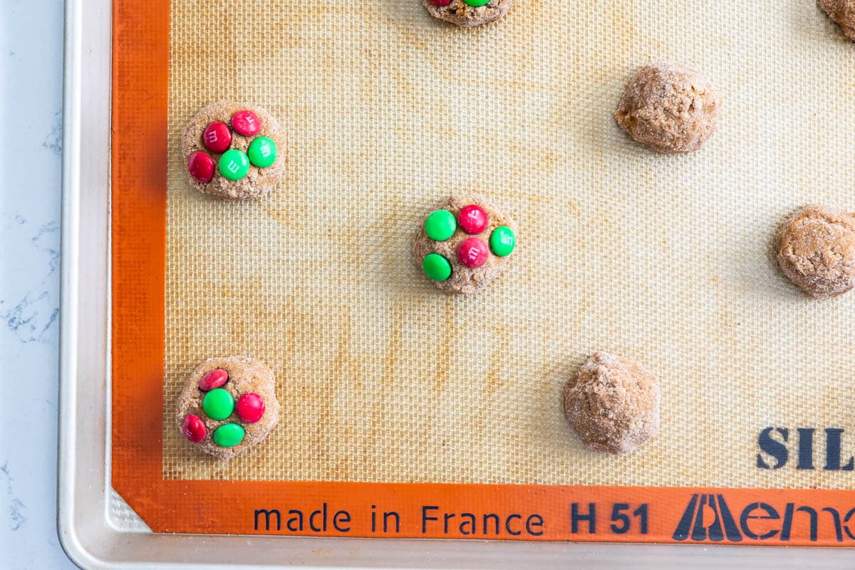 cookie dough on cookie sheet some with M&Ms