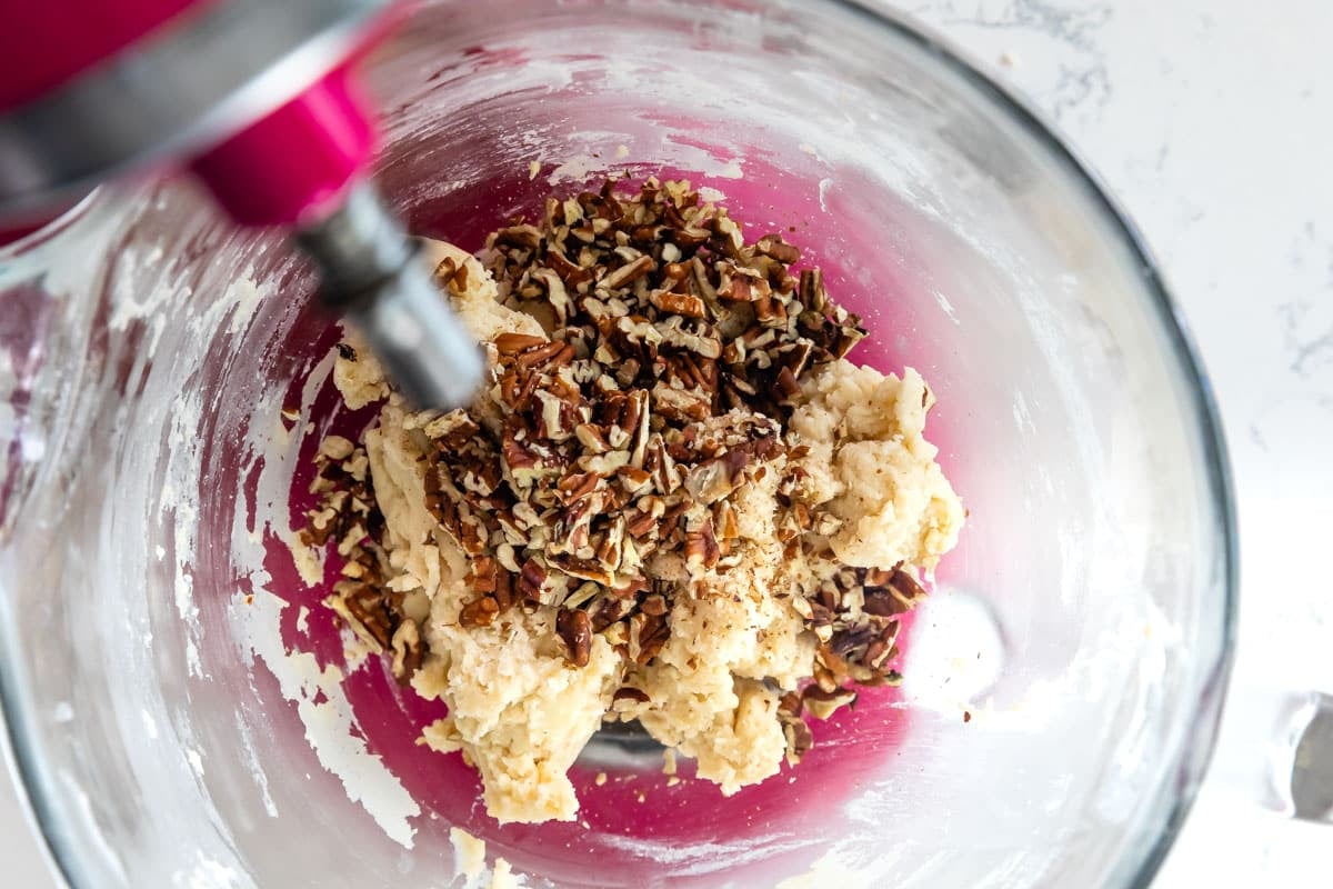 nuts added to cookie dough in stand mixer.