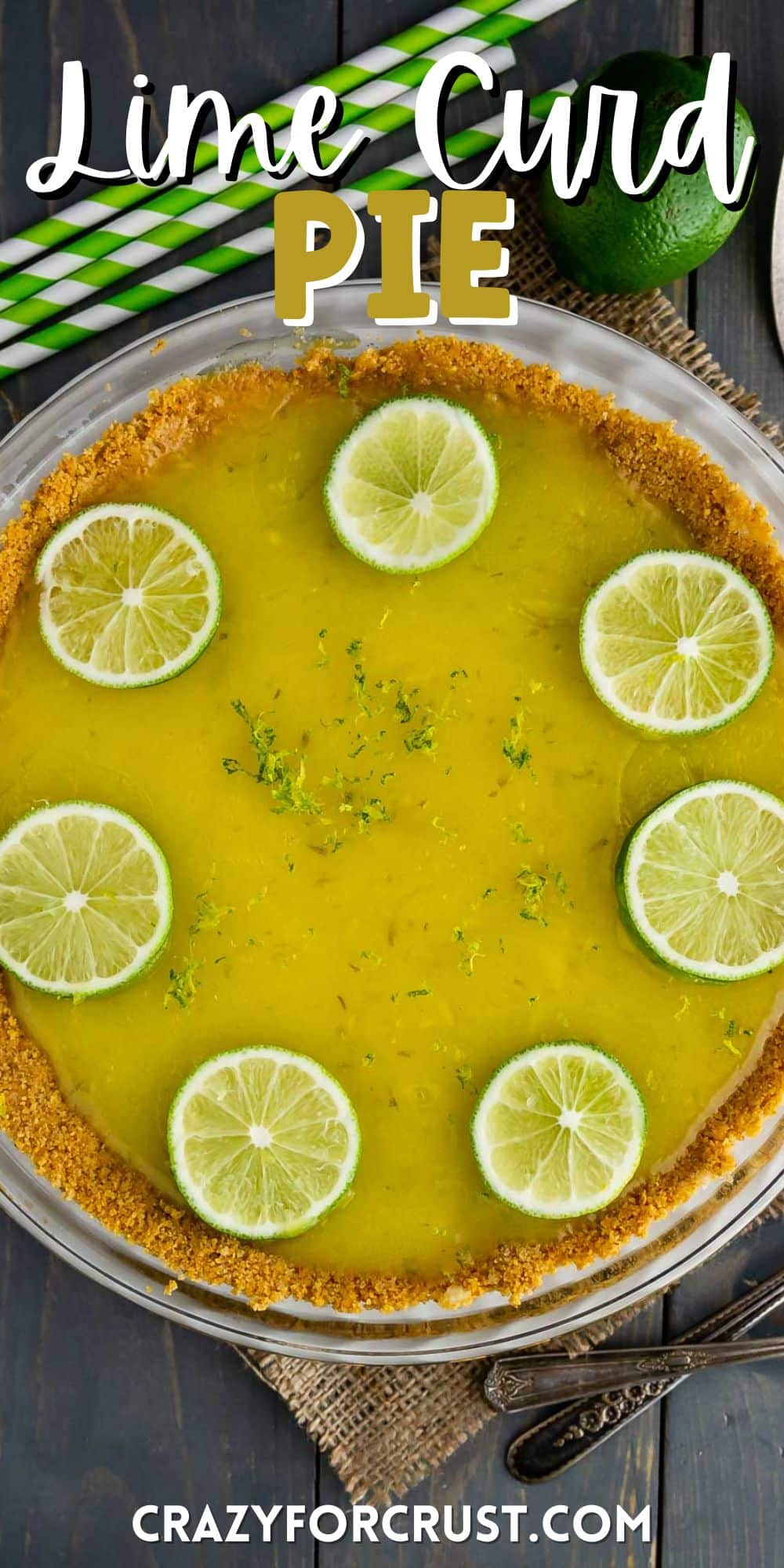 pie with graham cracker crust filled with lime filling and topped with sliced limes with words on top