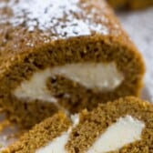 roll cut on a cutting board with powdered sugar on top with words on top