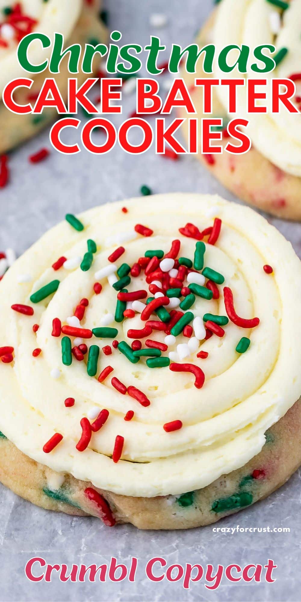 cookies with frosting and rainbow sprinkles on parchment