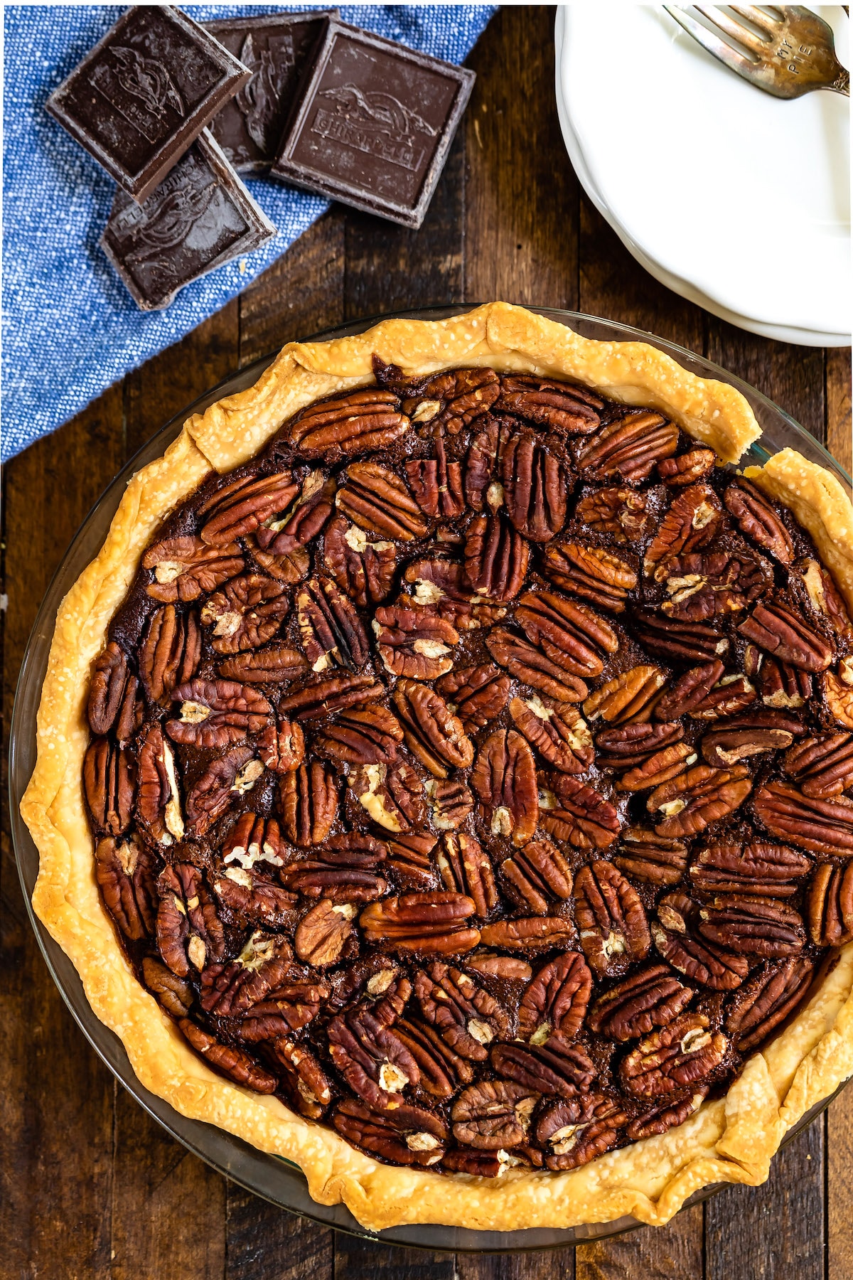 chocolate pecan pie on a wood board