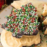 shortbread cookie dipped in chocolate and covered in christmas sprinkles