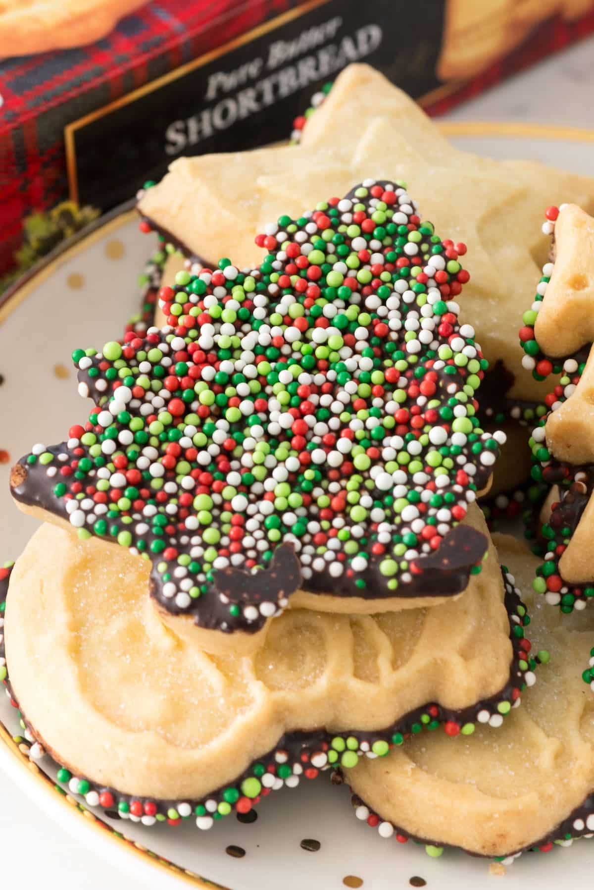 shortbread cookie dipped in chocolate and covered in christmas sprinkles