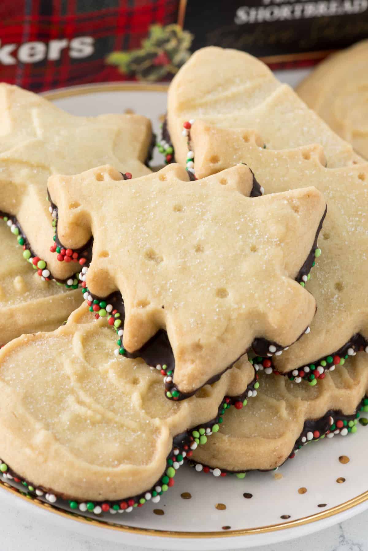 shortbread cookie dipped in chocolate and covered in christmas sprinkles