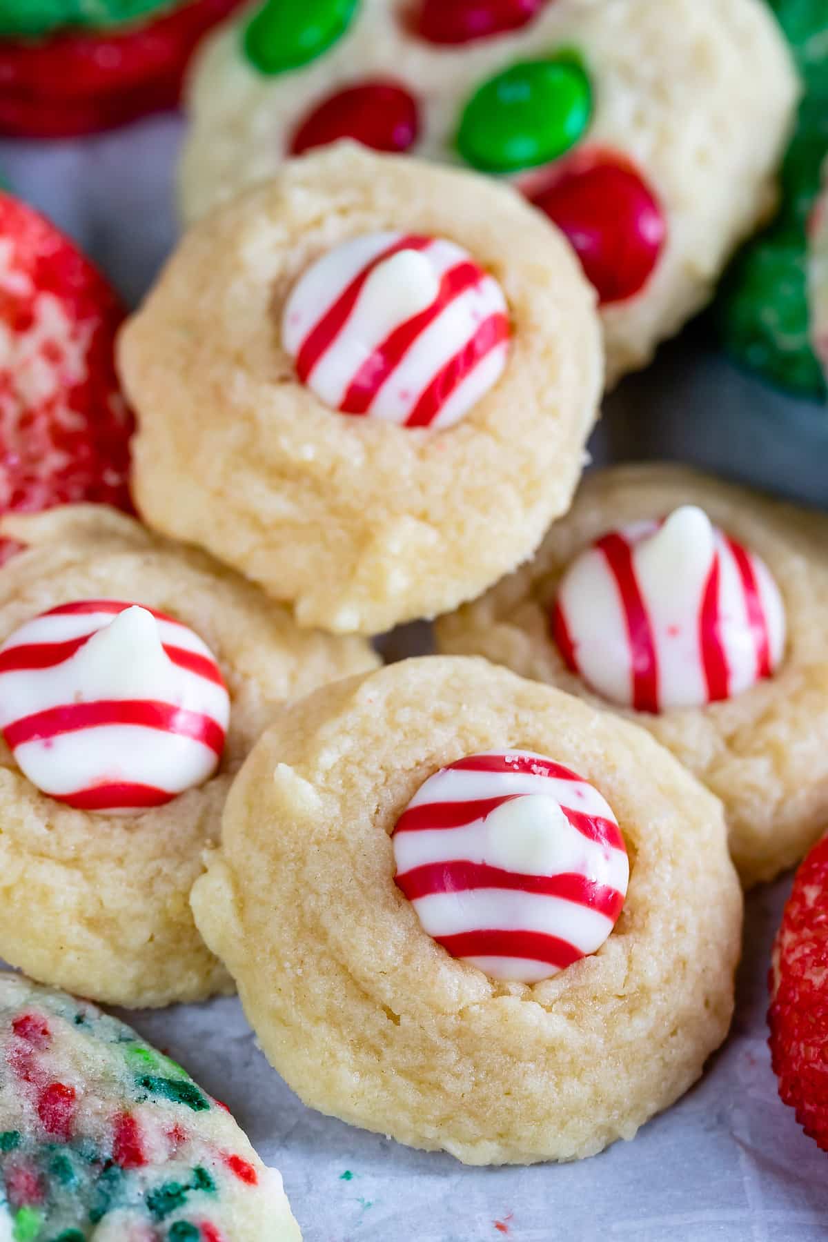 blossom cookies with red and white peppermint kiss in the middle of the cookie