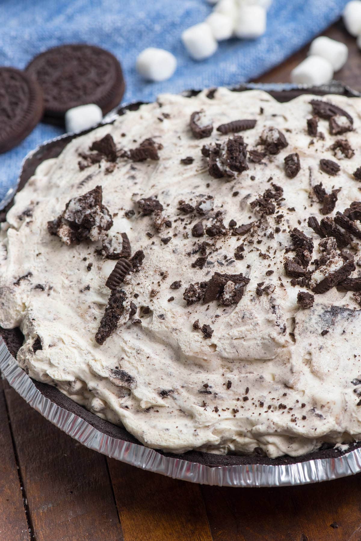 Oreo pie with crushed Oreos on top in a silver pie tin