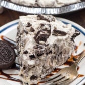 slice of oreo pie on a white plate with chocolate drizzled over top