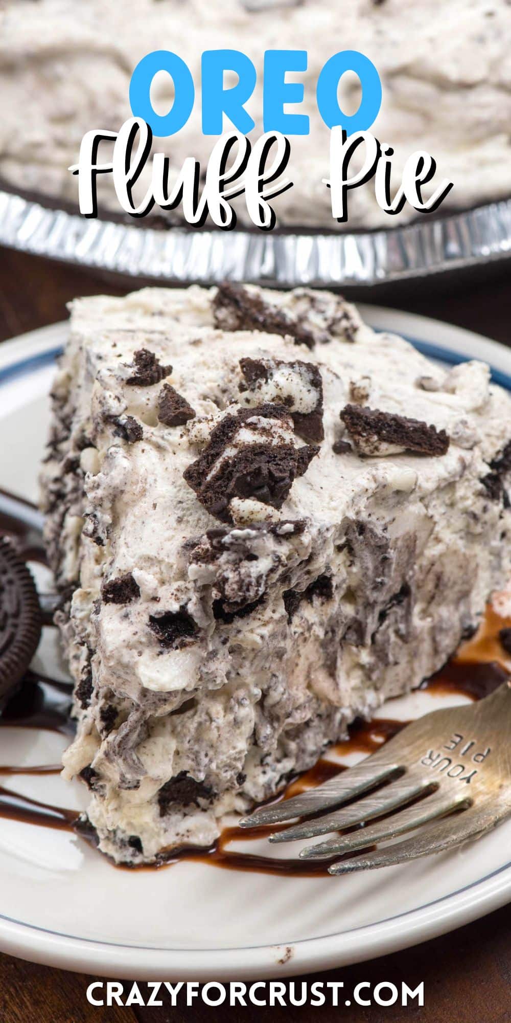slice of oreo pie on a white plate with chocolate drizzled over top and words on top