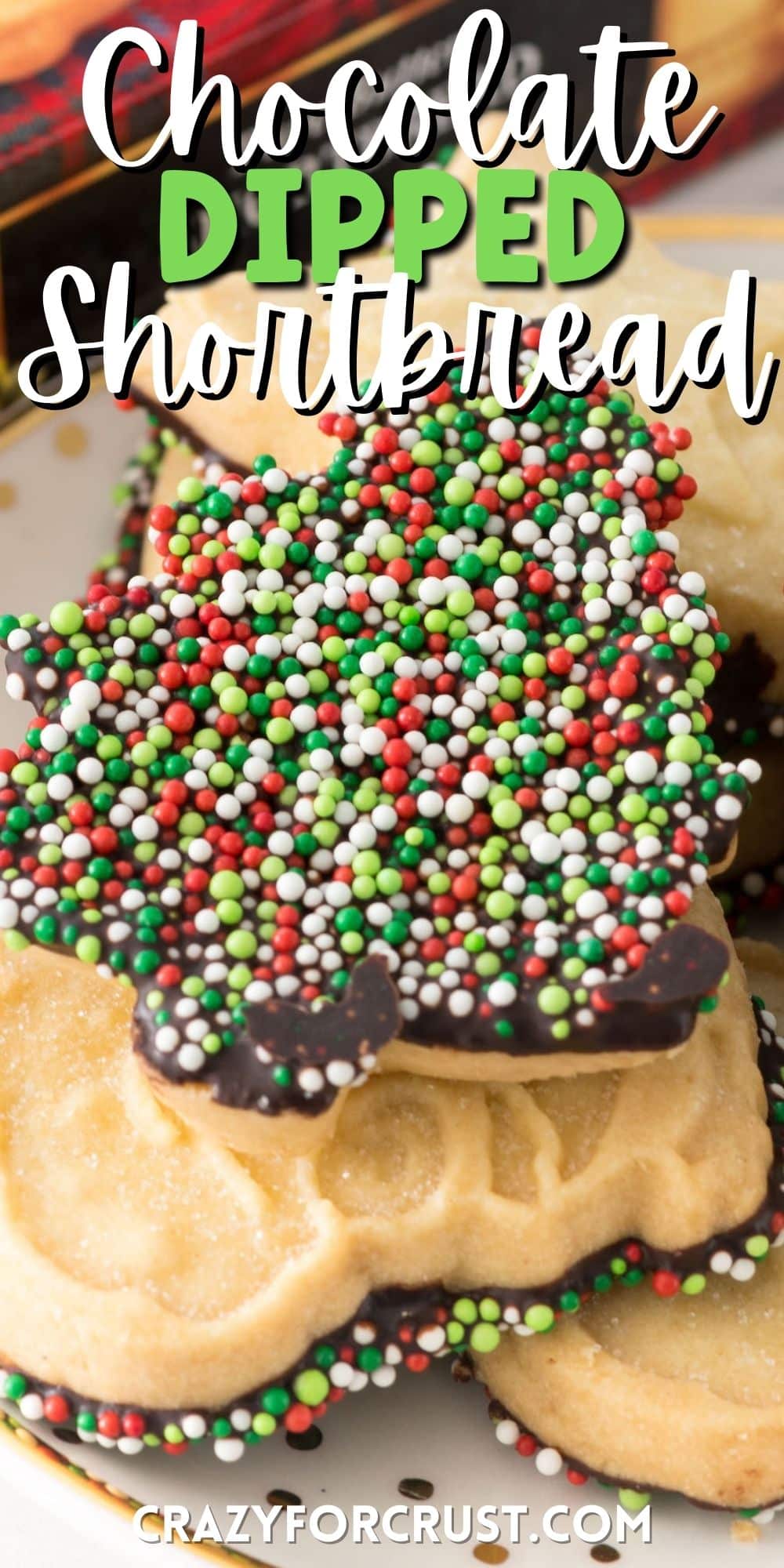 shortbread cookie dipped in chocolate and covered in christmas sprinkles with words on top