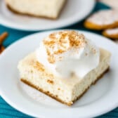 one square slice of cheesecake bars on a white plate with words on the photo saying the name of the recipe