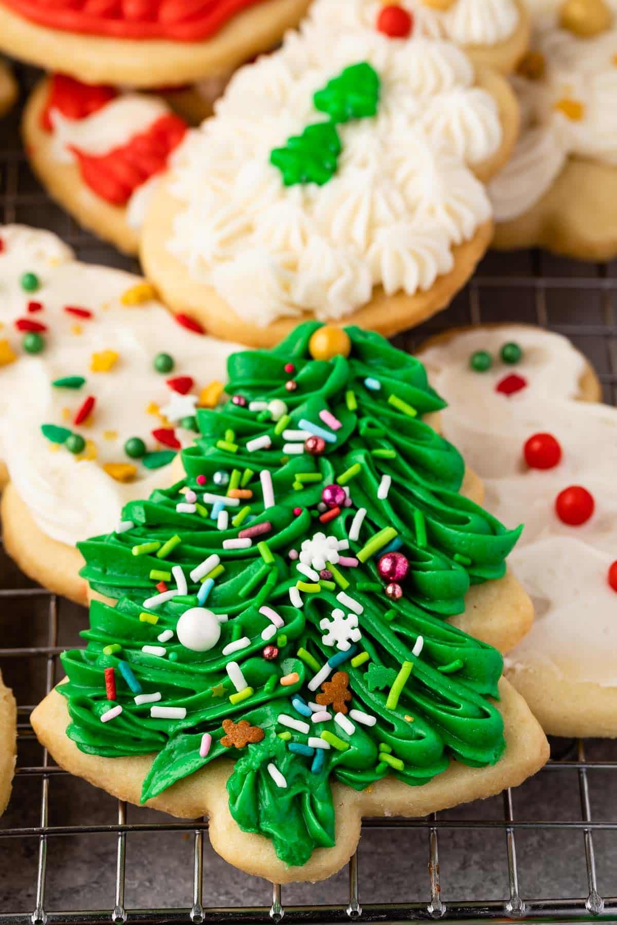 christmas shaped cookies with frosting decorating the cookies