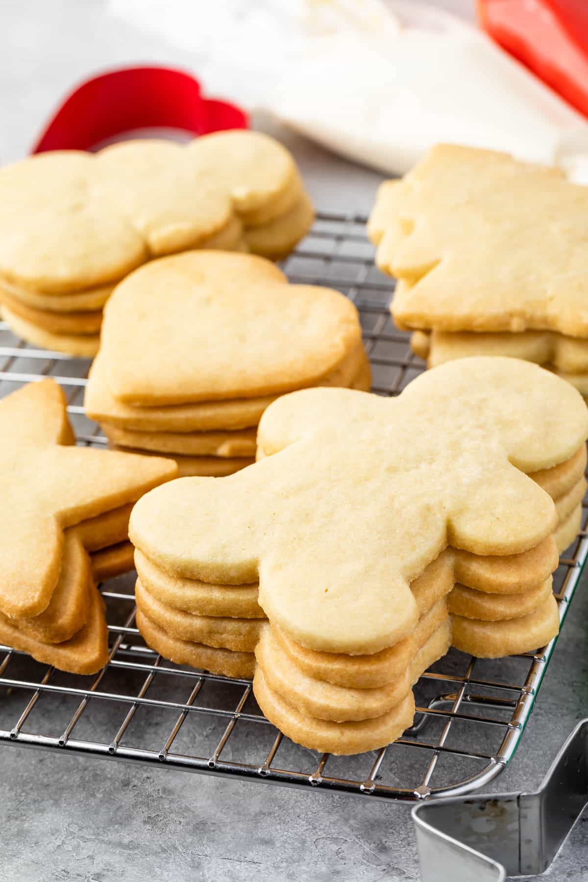 sugar cookies stacked on a drying rack