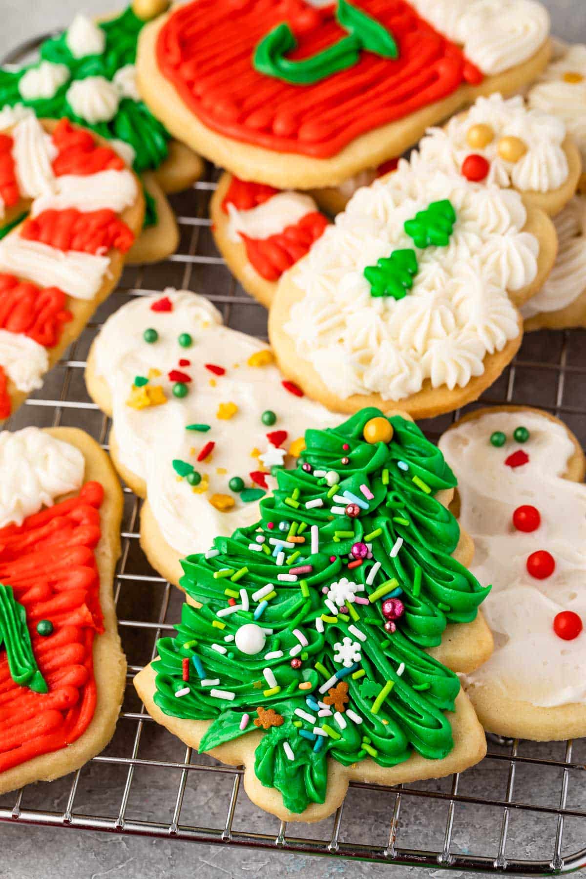 christmas shaped cookies with frosting decorating the cookies