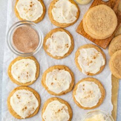 frosted eggnog cookies on parchment paper