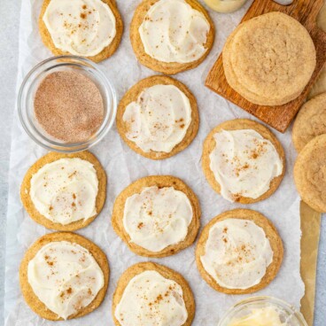 frosted eggnog cookies on parchment paper