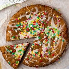 gingerbread cookie cake on parchment paper with sprinkles on top