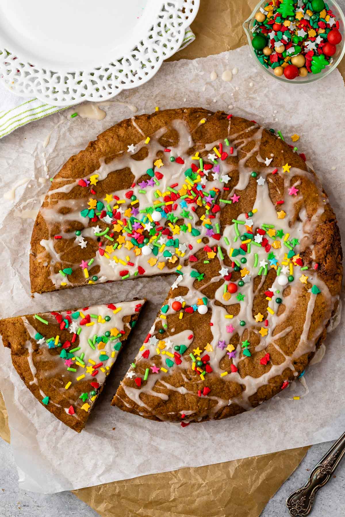 gingerbread cookie cake on parchment paper with sprinkles on top