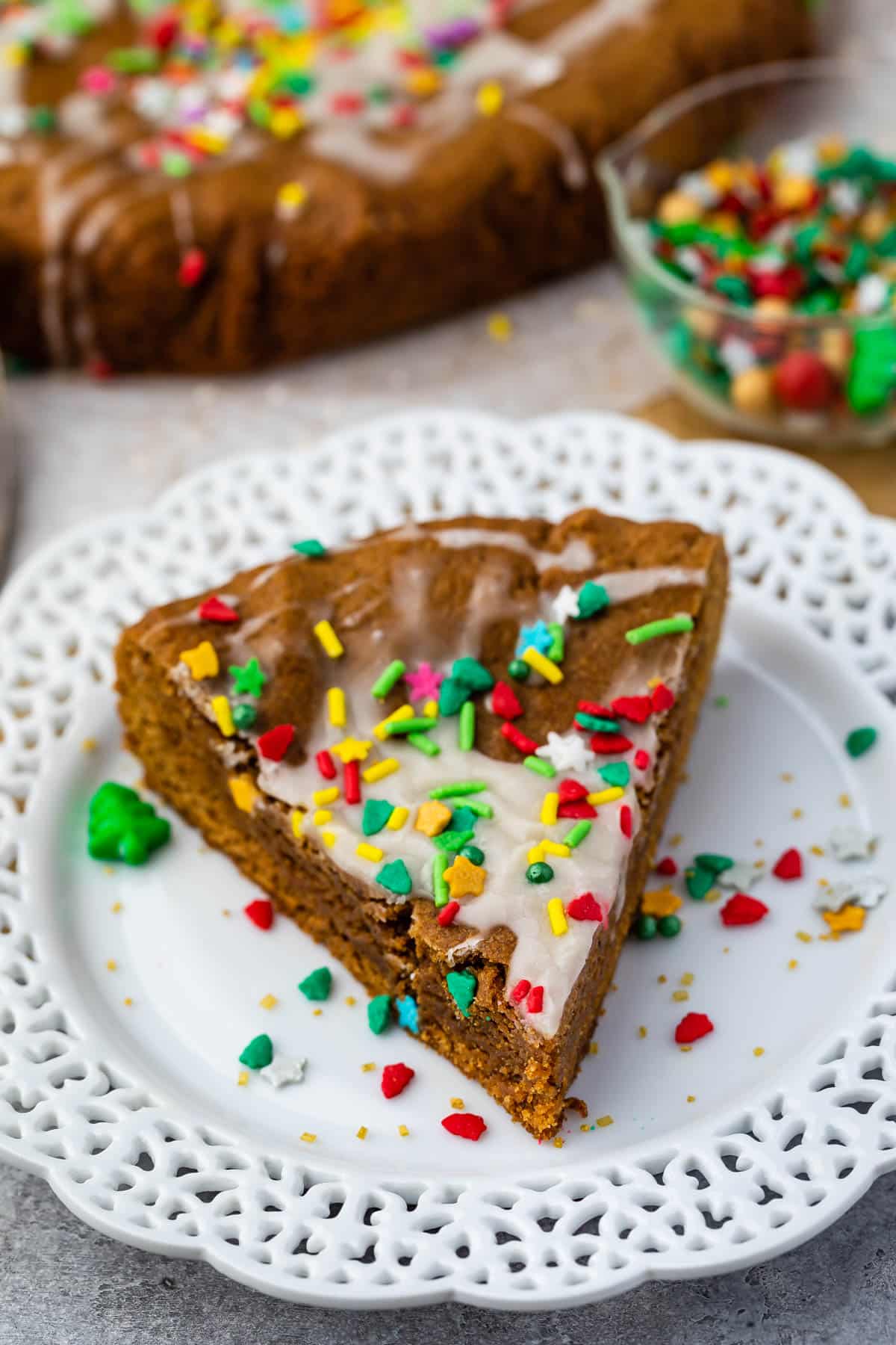 gingerbread cookie cake on a white plate with sprinkles on top