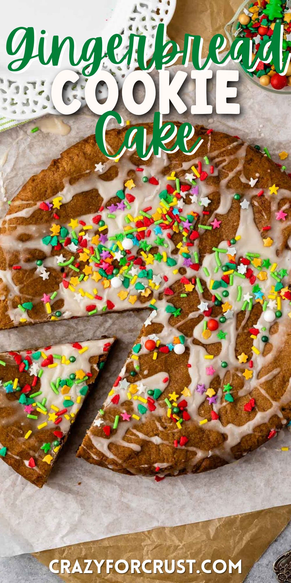 gingerbread cookie cake on parchment paper with sprinkles on top and words on top