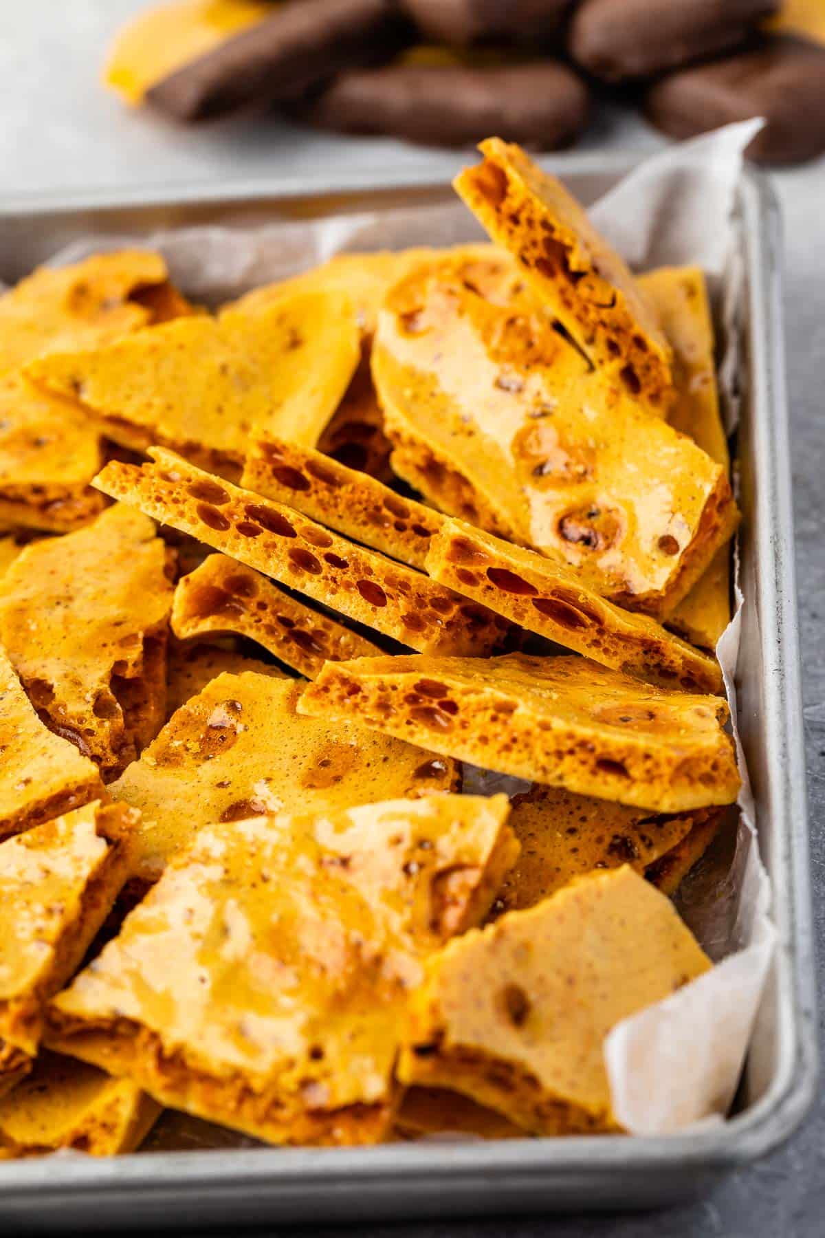 broken up honeycomb in a silver pan