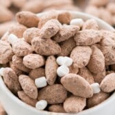 almonds in a white bowl mixed in with mini marshmallows with words on top