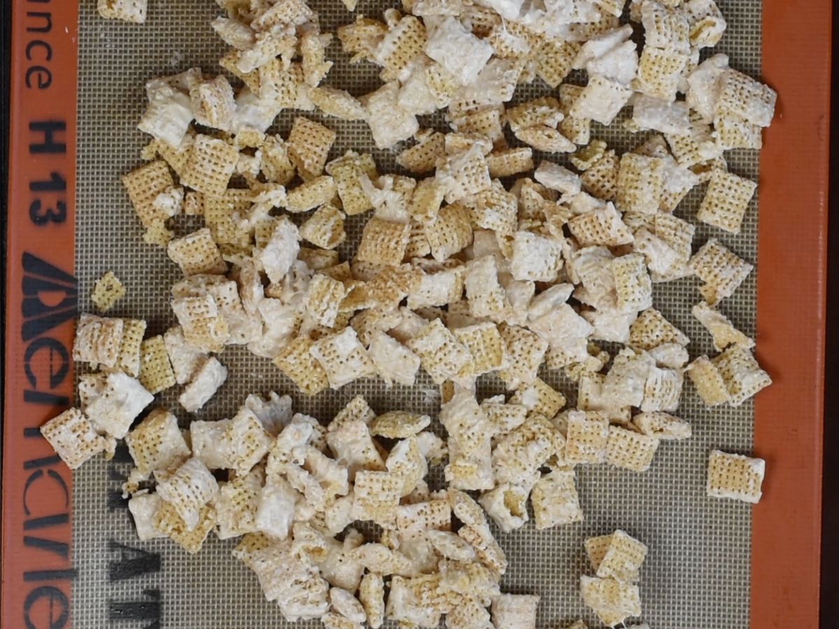 white chocolate coated Chex on cookie sheet lined with silpat.