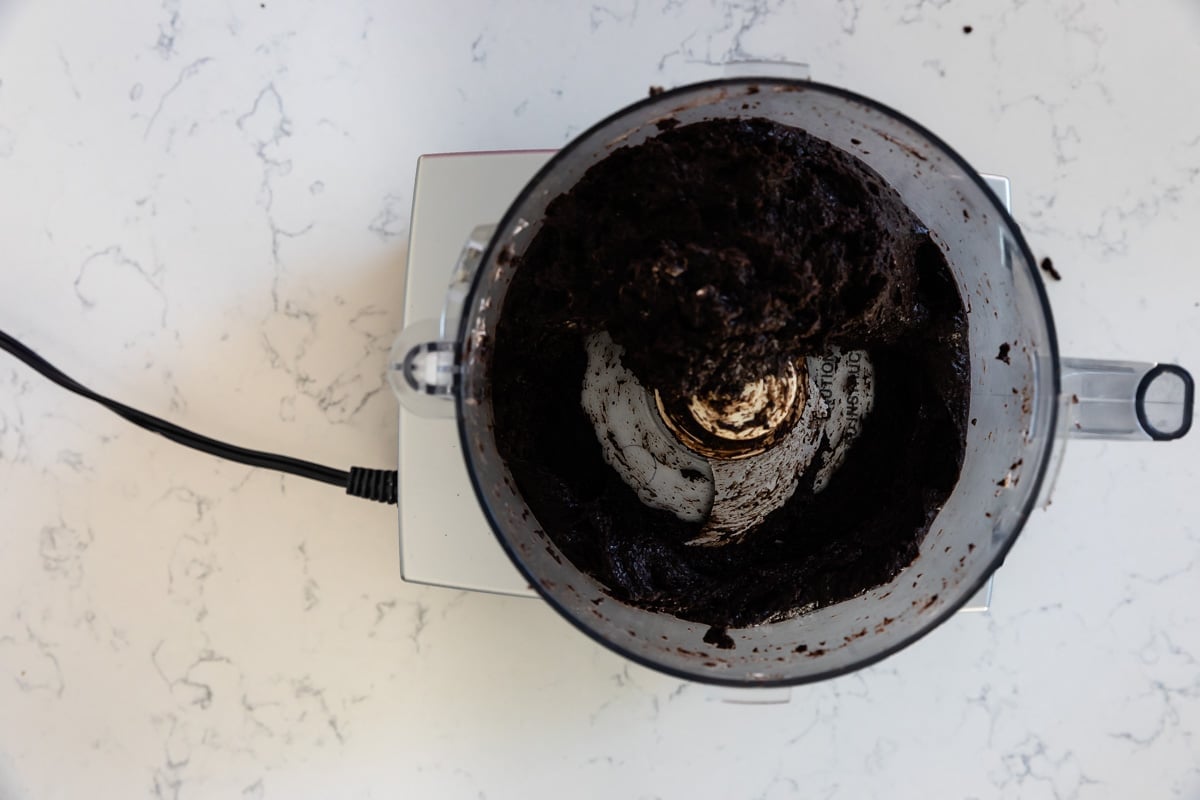 food processor with blended Oreos and cream cheese.