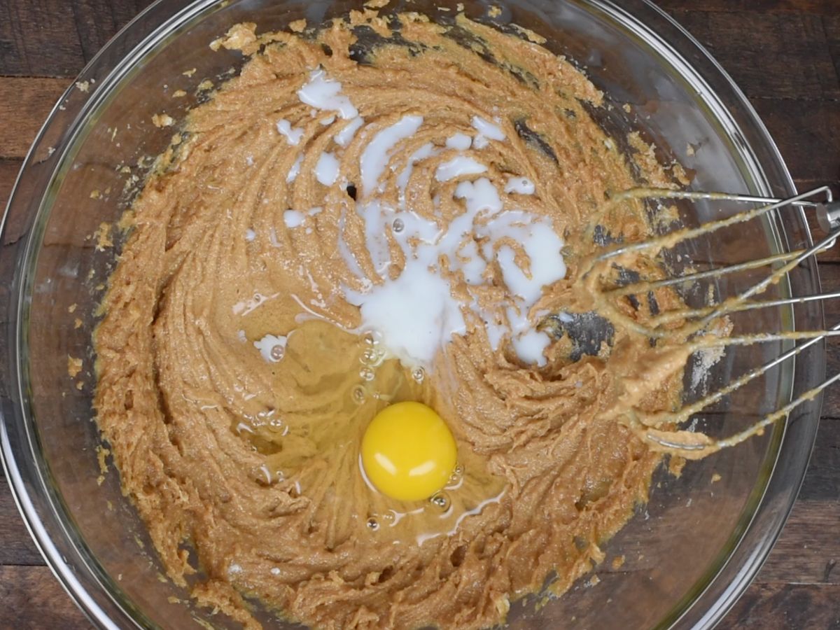 peanut butter cookie dough in bowl with egg and milk.