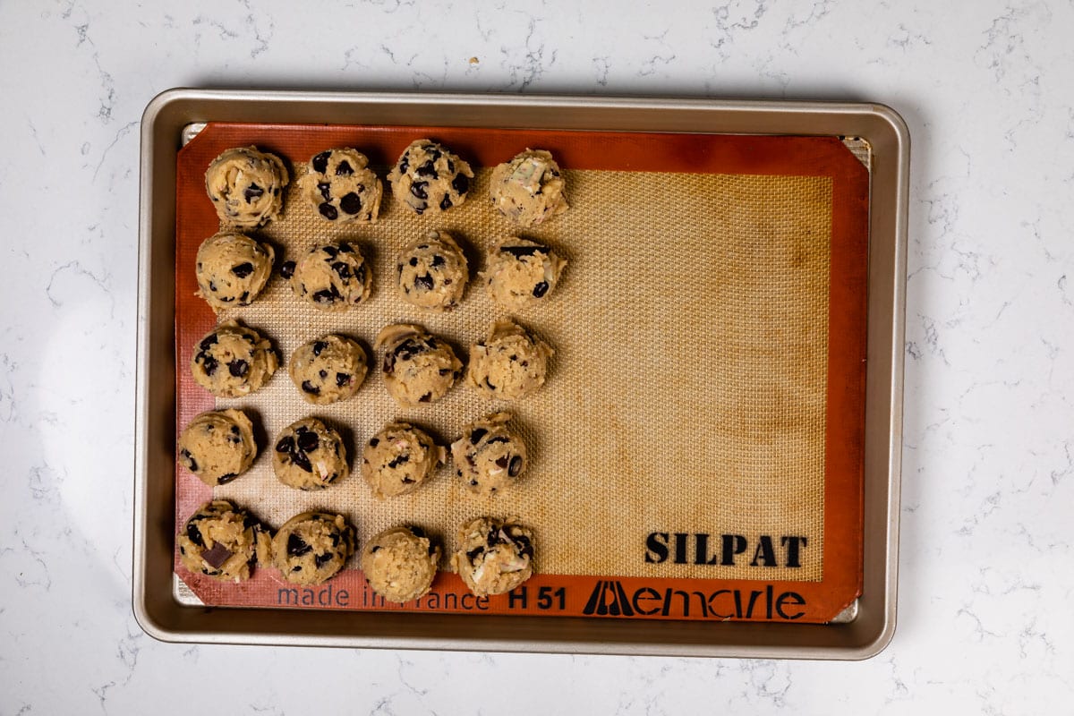 cookie dough balls on cookie sheet