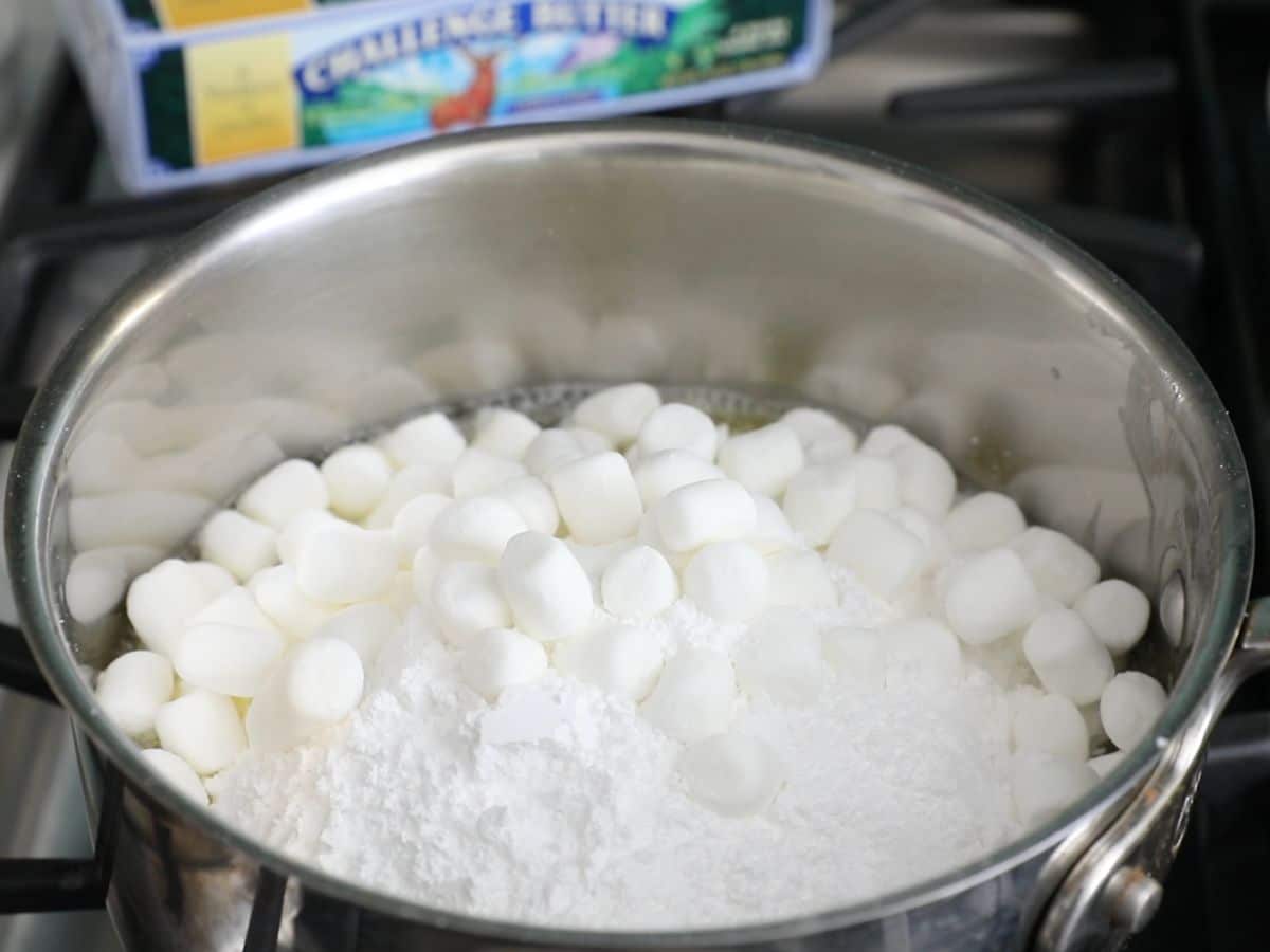 pot on stove with marshmallows and powdered sugar.