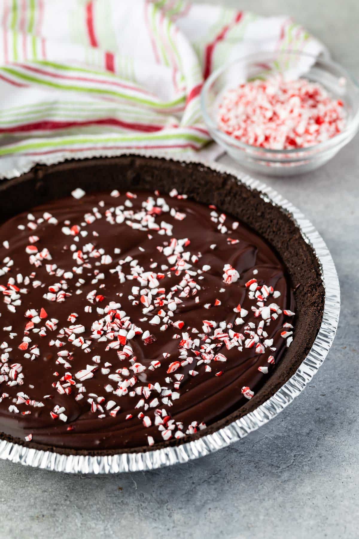 ganache pie in a pie tin with peppermint crushed on top