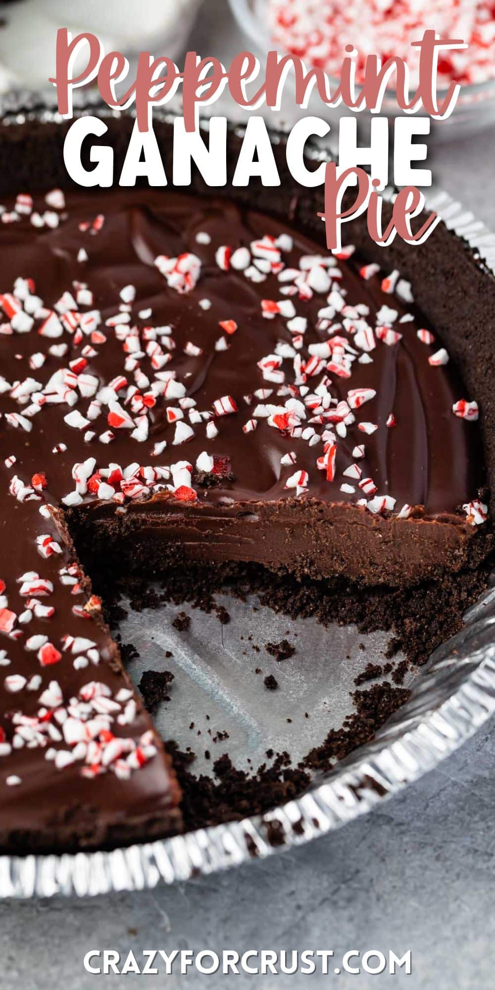 ganache pie in a pie tin with a slice taken out of the pan with words on top