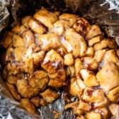 monkey bread covered in icing sitting in a slow cooker