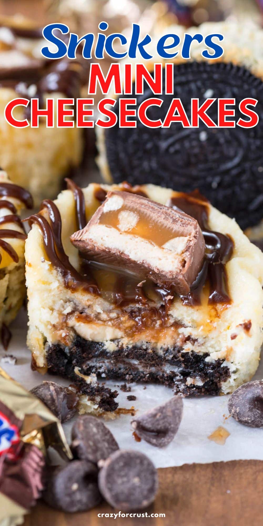 cheesecake cut in half with snickers bar on top