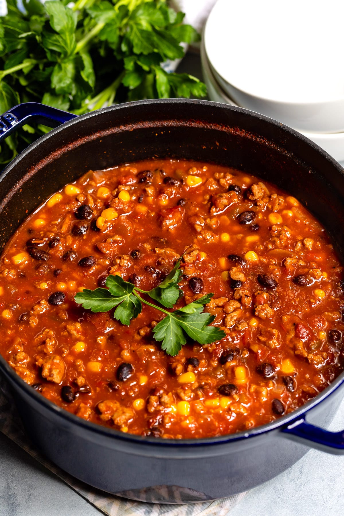 chili in a black pan with garnish on top