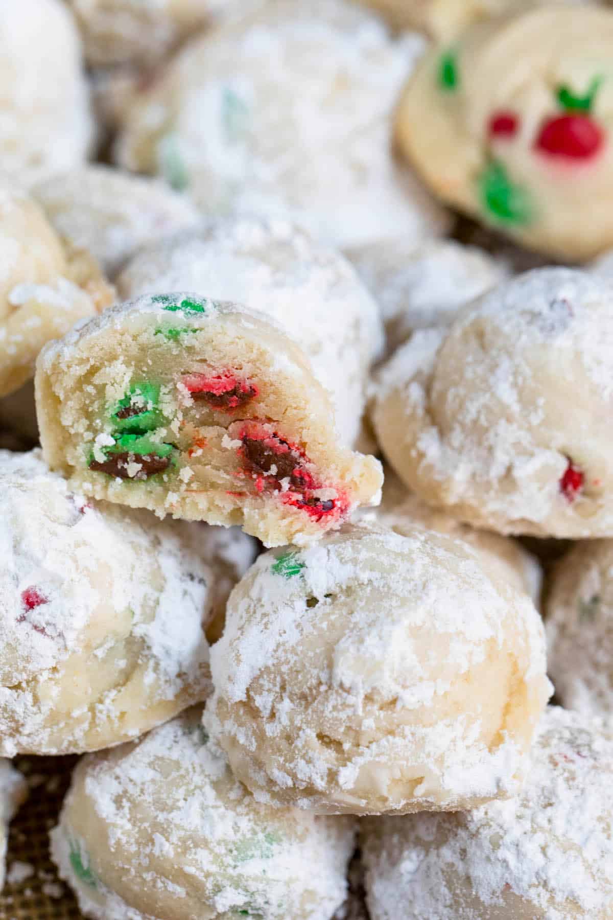 snowballs covered in powdered sugar with red and green m&ms baked in