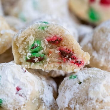 snowballs covered in powdered sugar with red and green m&ms baked in