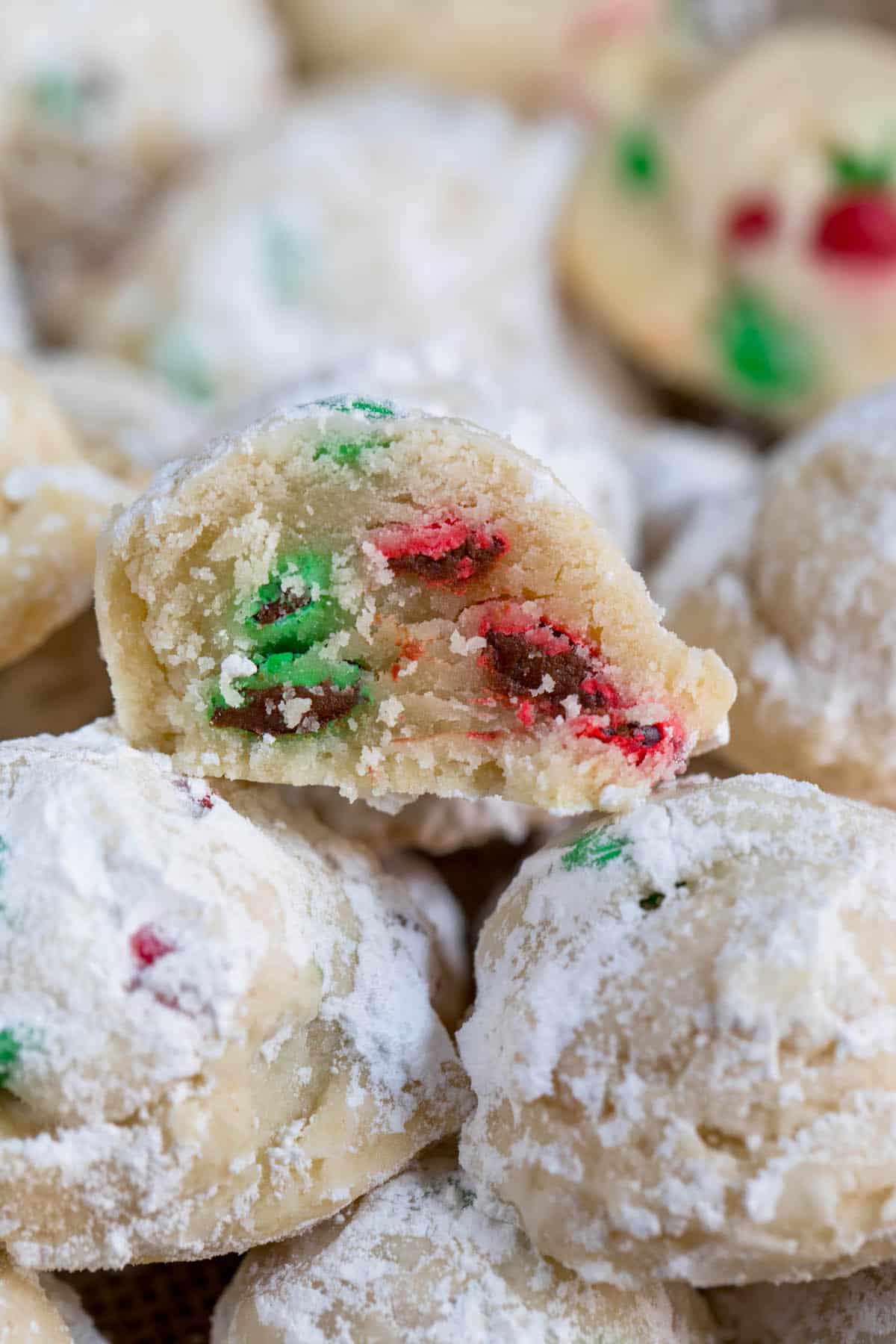 snowballs covered in powdered sugar with red and green m&ms baked in