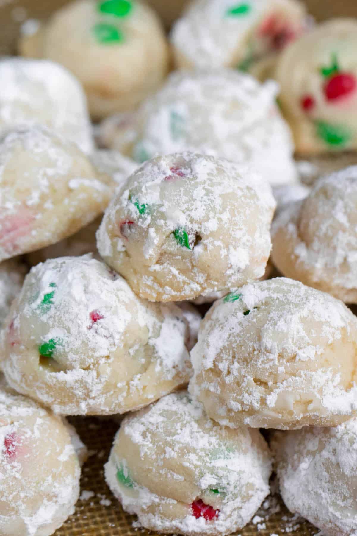 snowballs covered in powdered sugar with red and green m&ms baked in