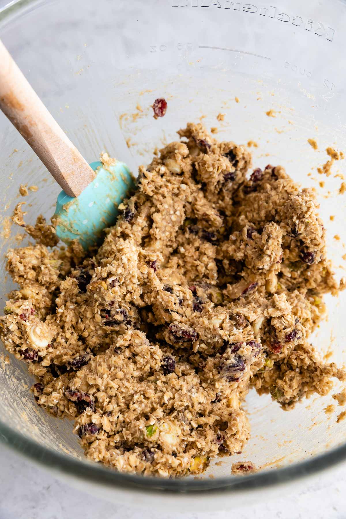 oatmeal cookie dough in bowl with spatula.