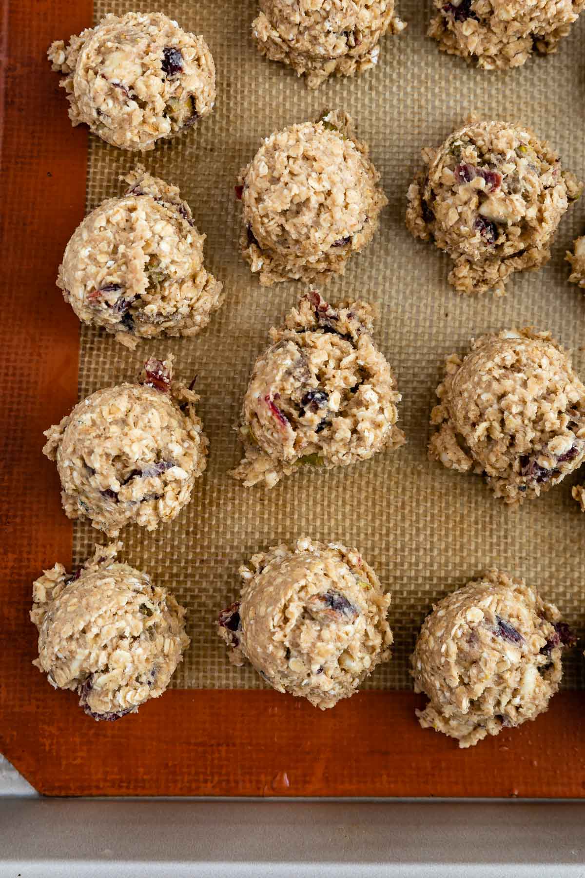 cookie dough balls on silpat lined cookie sheet.