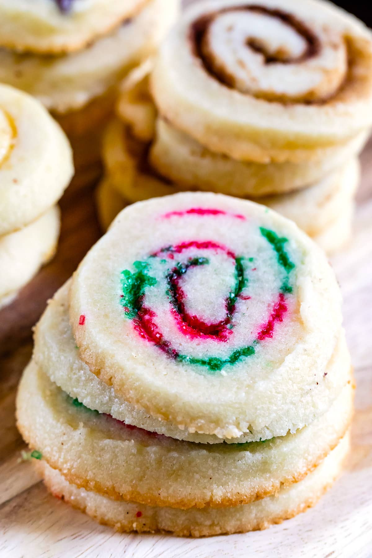 swirl cookies stacked with red and green sprinkles in the middle