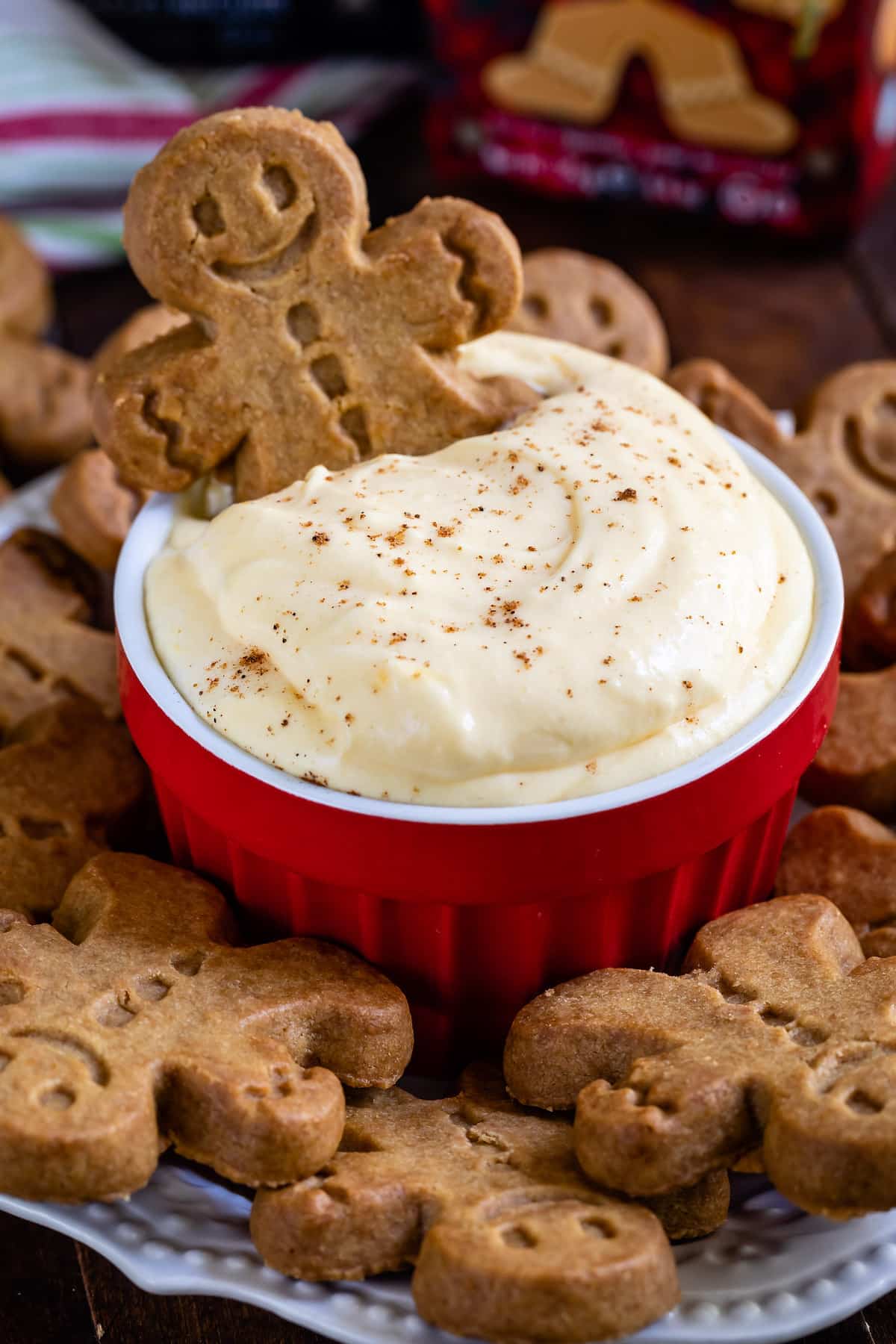 cookie in pudding in red bowl surrounded by cookies