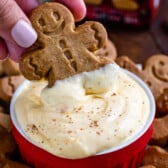 hand dipping cookie in eggnog pudding
