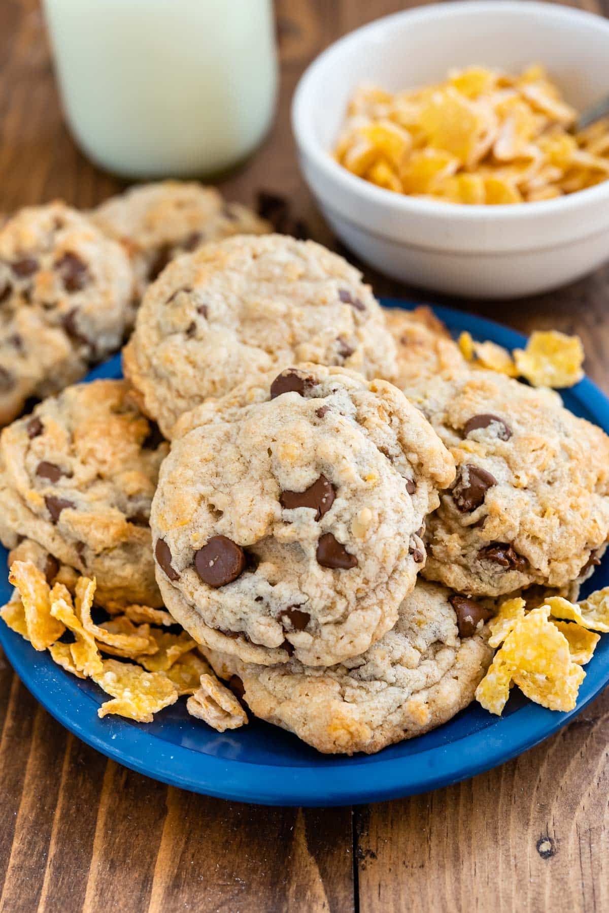 stacked frosted flake cookies with chocolate chips baked in on a blue plate