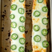 bread with jalapeños on top on a cooking sheet